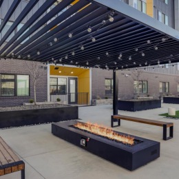 a building with a covered patio and firepit