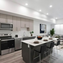 a kitchen with stainless steel appliances and an island with bar stools