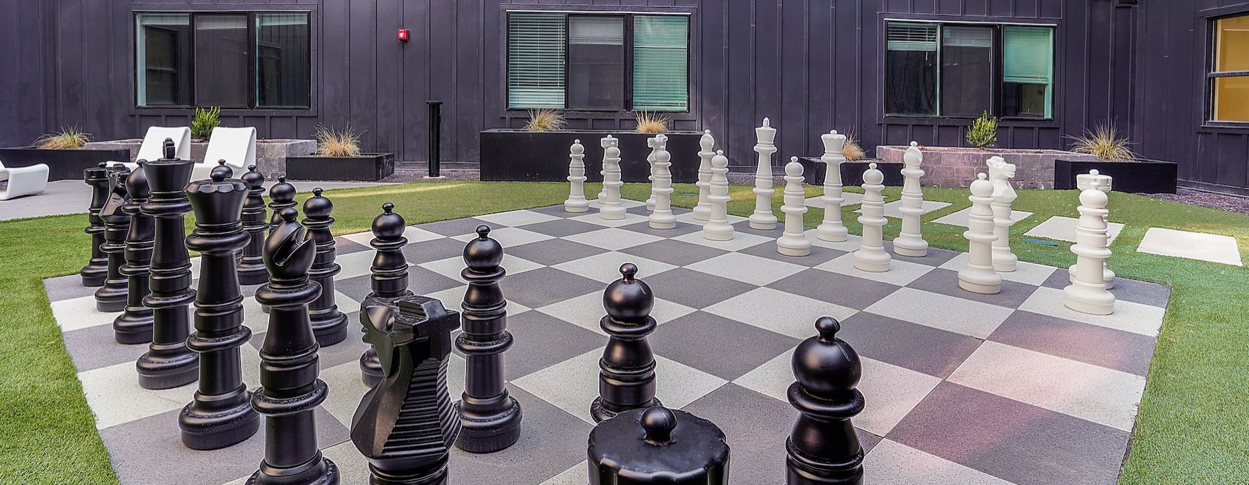 a large chess board in front of a building