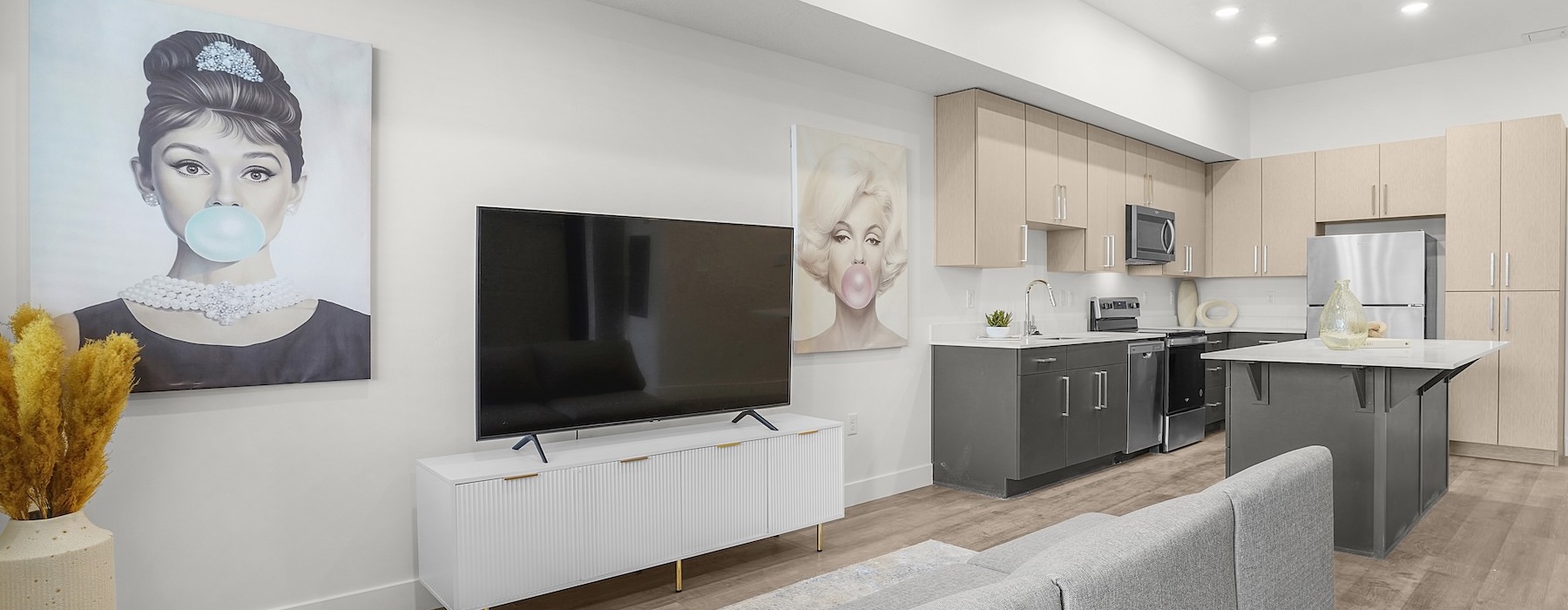 living area with a couch, tv and art on the wall