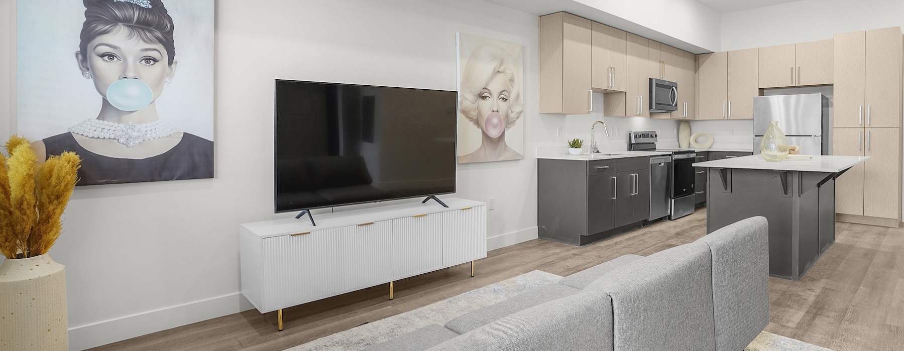 living area with a couch, tv and art on the wall