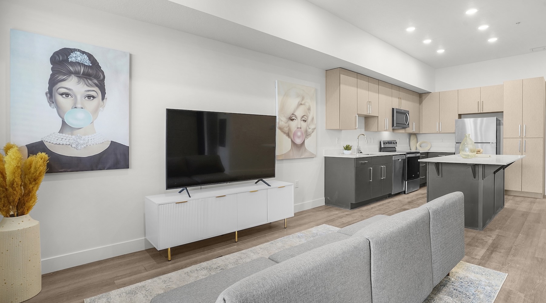 living area with a couch, tv and art on the wall